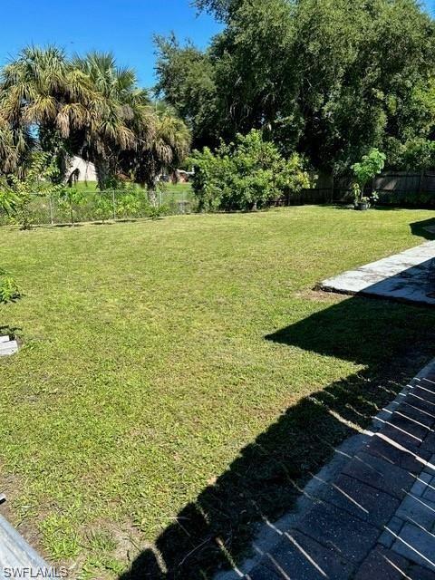 Expansive lawn featuring mature trees and lush landscaping