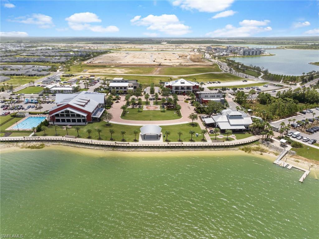 Waterfront development featuring multiple commercial buildings, a swimming pool, and extensive parking facilities