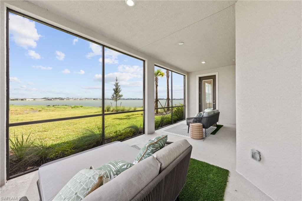 Screened patio with large format screen panels, recessed lighting, and a dark-framed exterior door
