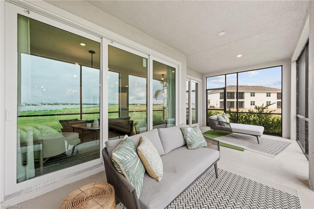 Screened patio with concrete flooring, recessed lighting, and expansive sliding glass doors
