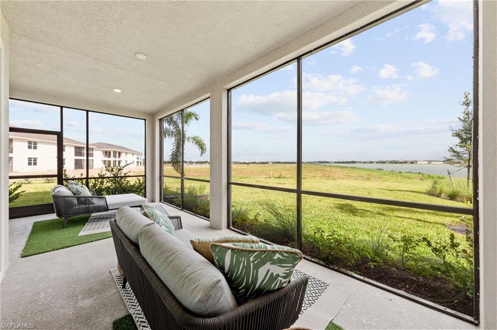Screened-in outdoor living space with recessed lighting and a concrete floor