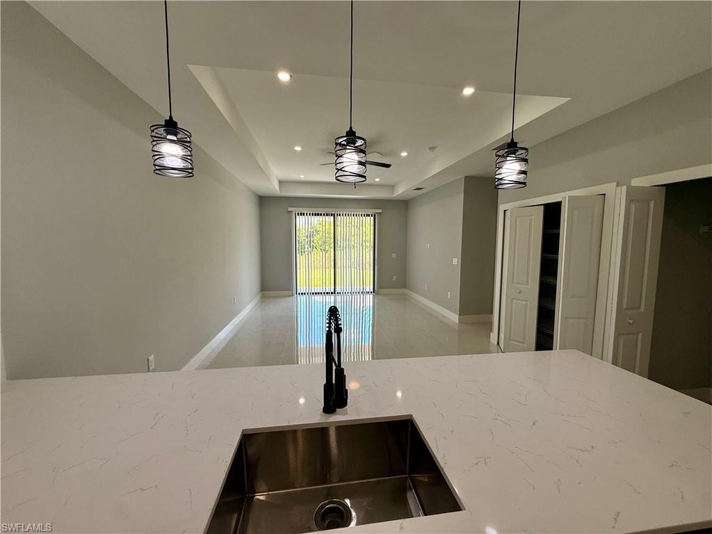 Quartz countertop with an undermount sink and matte black faucet