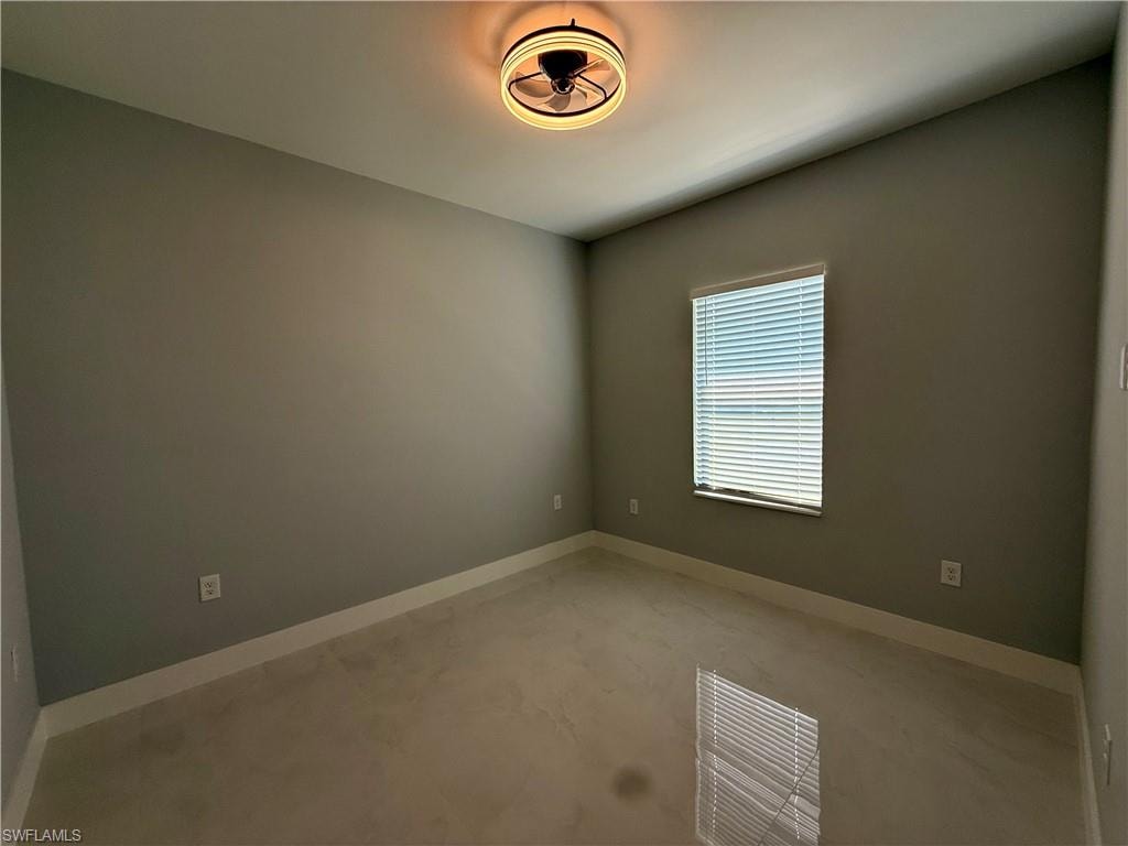 Recessed lighting fixture, light gray wall paint, window with blinds, light tile flooring, and white trim molding