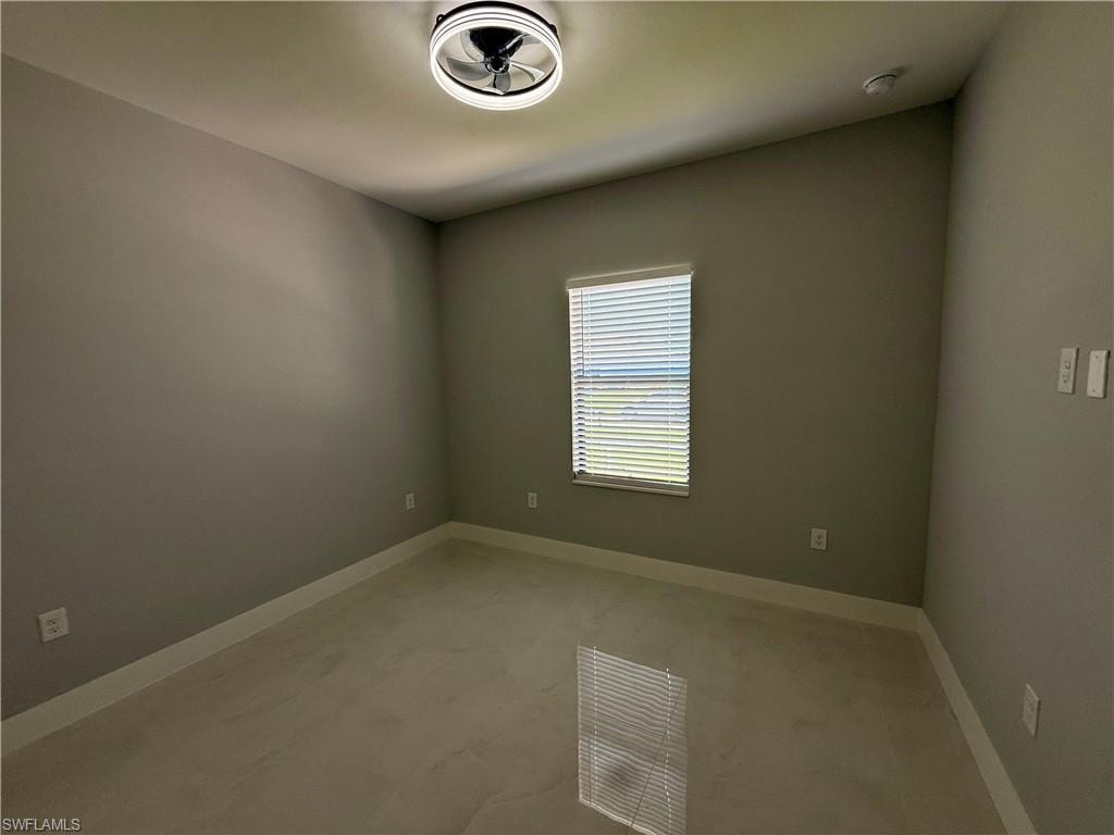Recessed window with blinds, ceiling-mounted fan, light neutral wall paint, and light-toned tile flooring