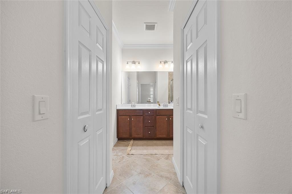 Dual bi-fold doors frame a hallway with tile flooring