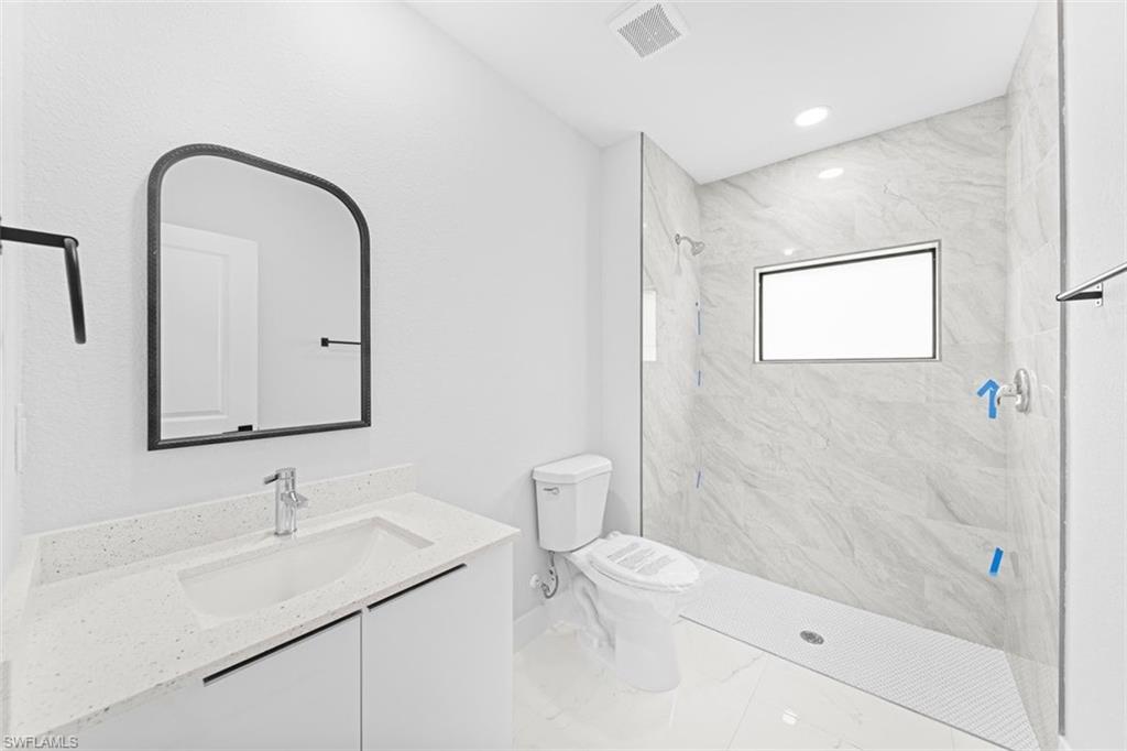 Vanity with integrated sink and chrome faucet