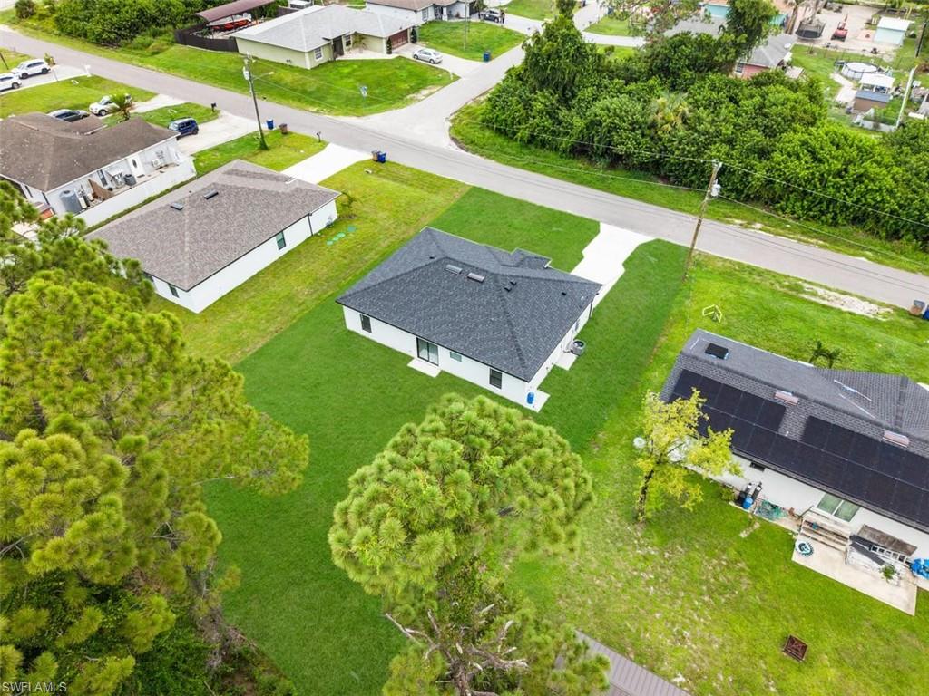 Newly constructed residence featuring a dark shingle roof and white exterior
