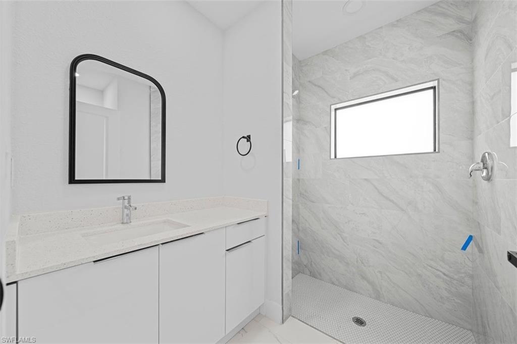 Vanity with a light-toned countertop and an integrated sink