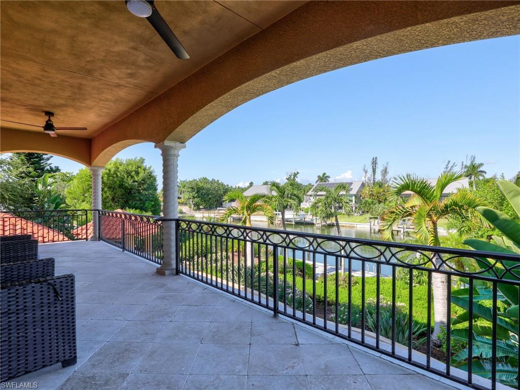 Covered balcony featuring archways and decorative columns