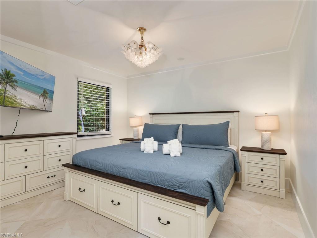 Recessed lighting illuminates the room, complemented by a decorative ceiling fixture