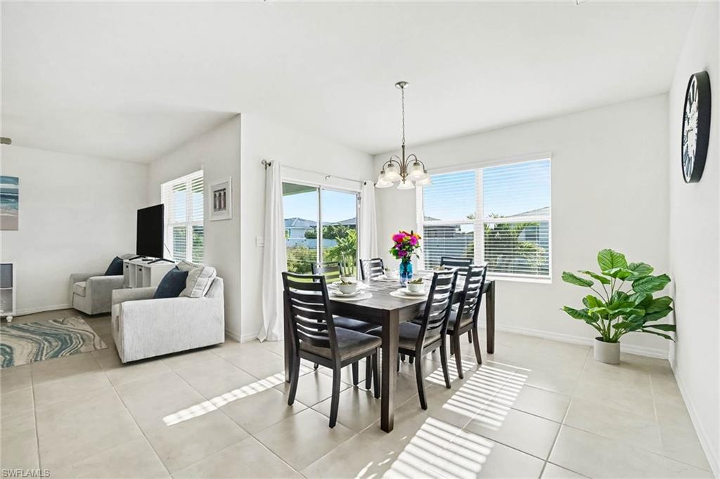 Expansive tile flooring, bright white wall finishes, and a contemporary pendant light fixture