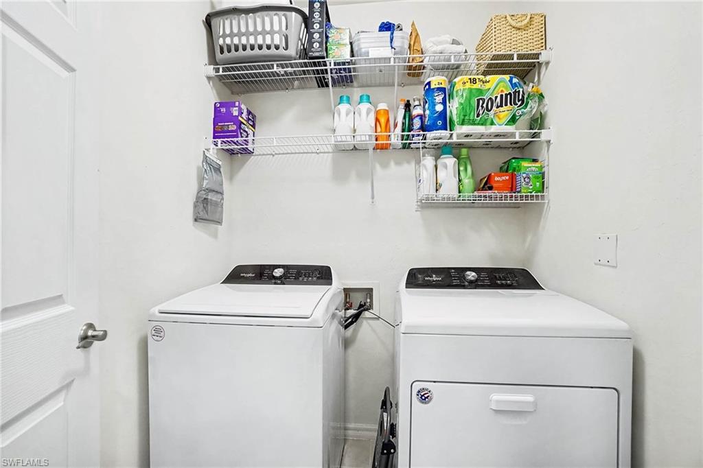 White walls with wire shelving, featuring a white washing machine and a white dryer