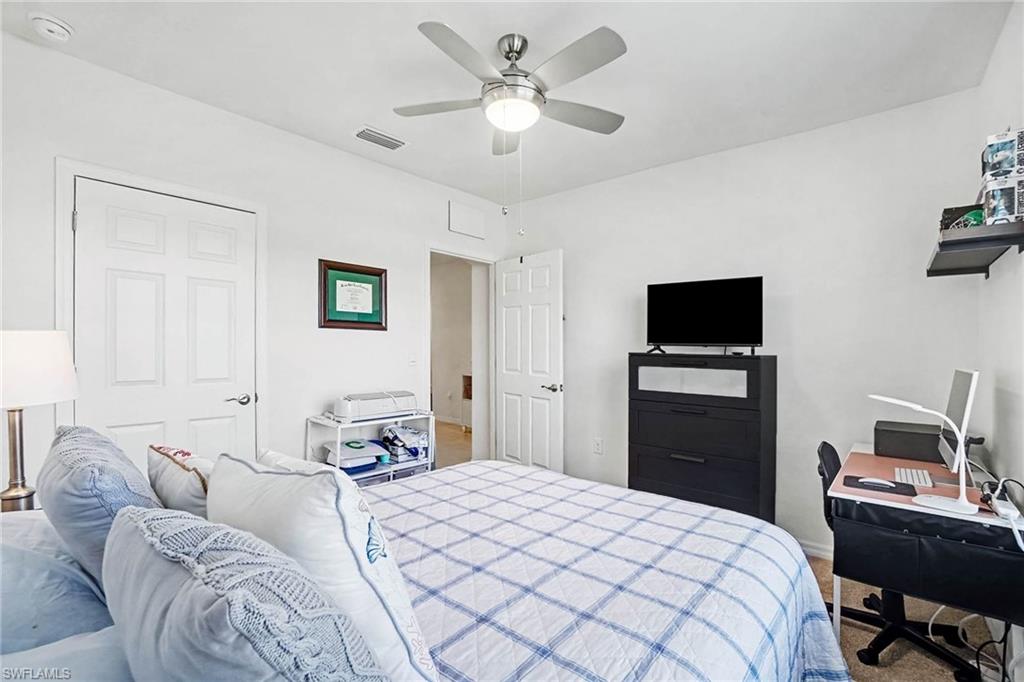 White paneled doors, ceiling fan with integrated lighting, and neutral wall finishes