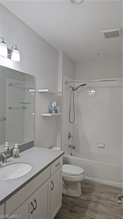White vanity with integrated sink and dark grey countertop