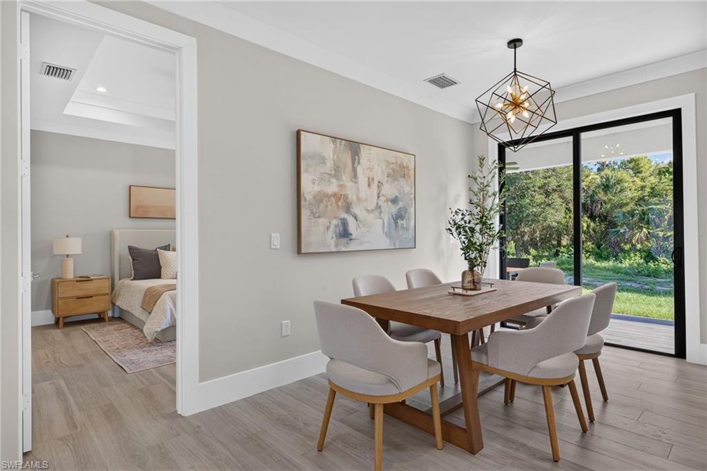 Wood-finish flooring, recessed lighting, and a modern geometric chandelier