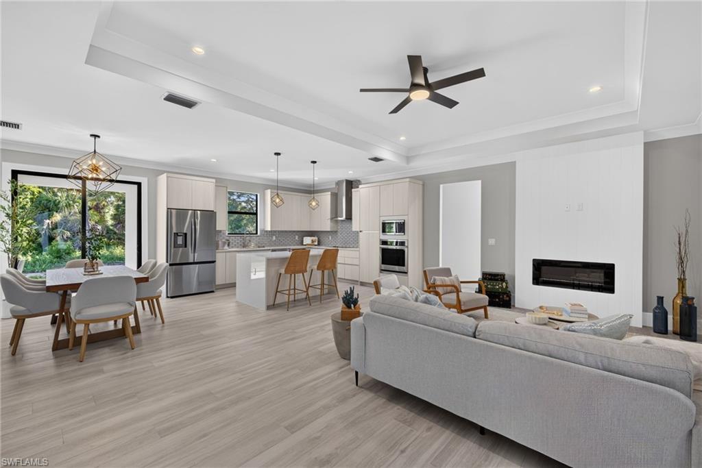 Wood-finish flooring, recessed lighting, and a tray ceiling