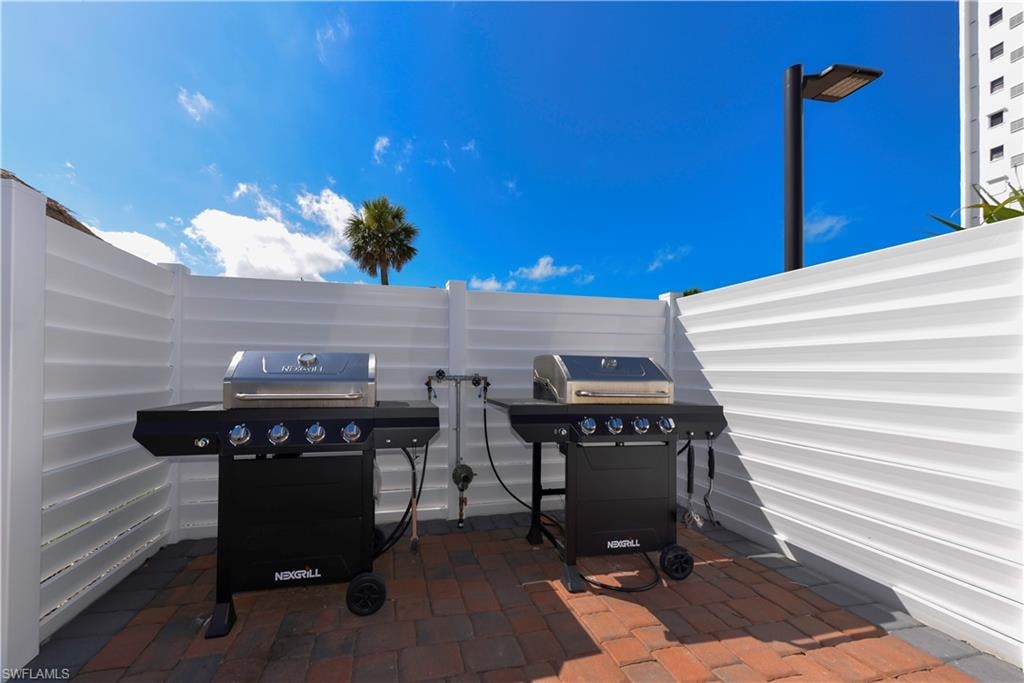 Grill Area beside large Tiki in from of Building