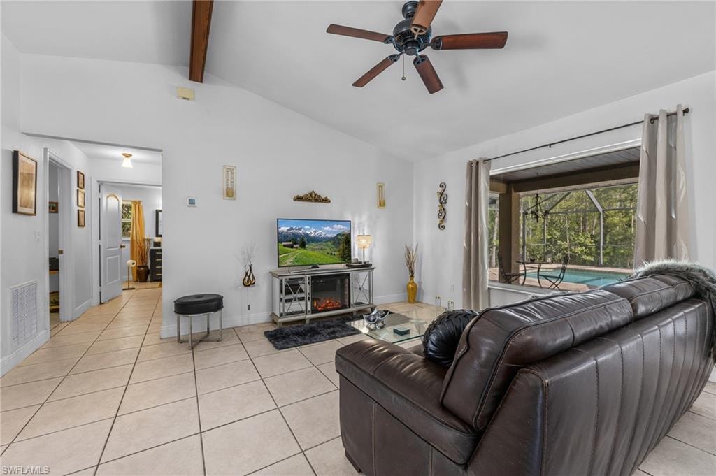 Vaulted ceiling with exposed wood beams and a ceiling fan