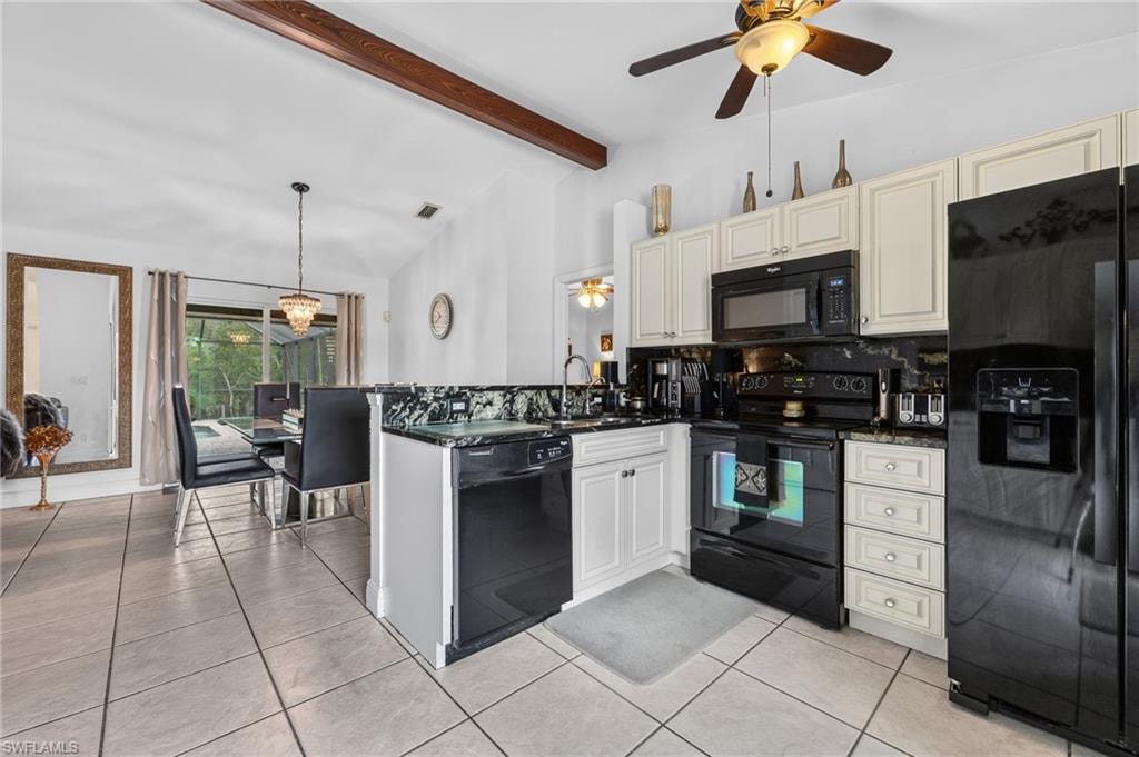 Kitchen with light-toned cabinetry, black appliances, dark countertop and backsplash, and tile flooring