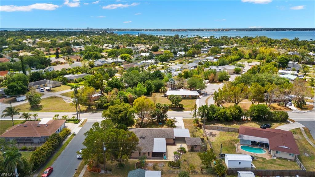 Residential neighborhood setting with mature trees and visible waterways