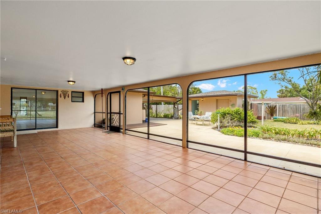Screened patio featuring tile flooring and two ceiling-mounted light fixtures
