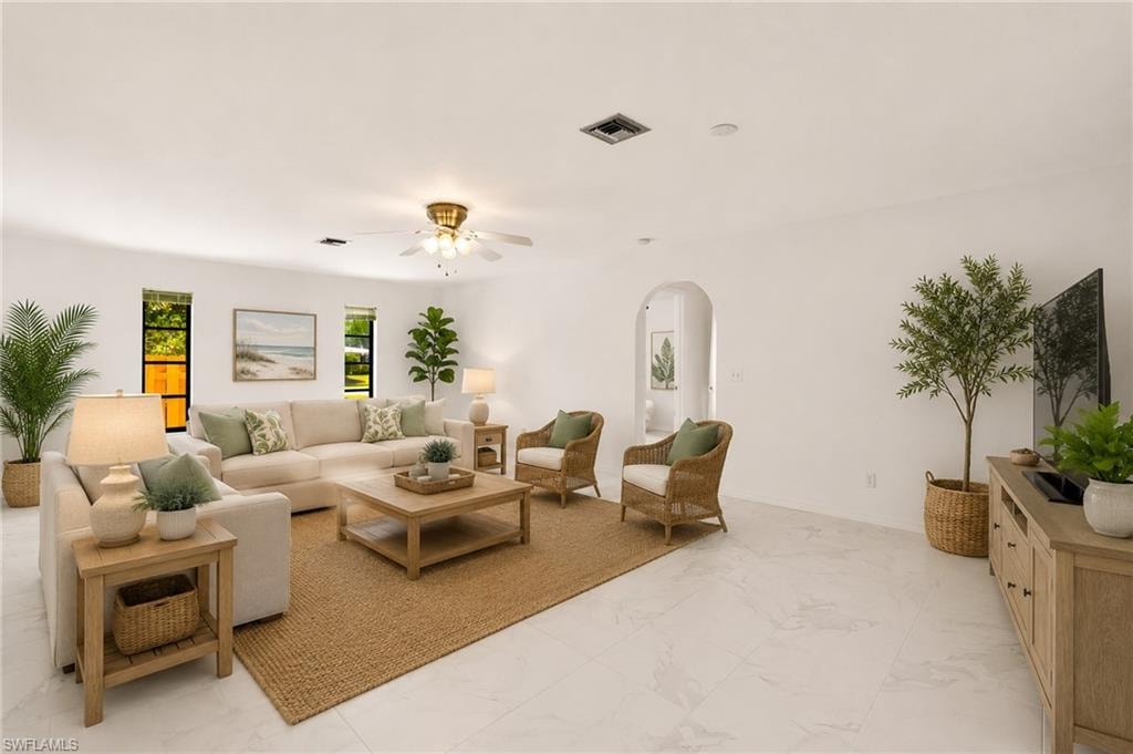 VIRTUAL White interior walls, recessed lighting, ceiling fan with integrated light fixture, multiple windows, and arched doorway