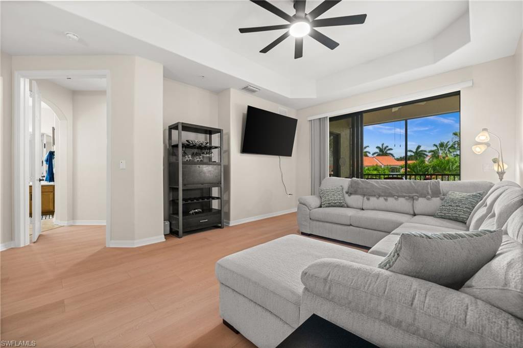 The living room boasts beautiful outdoor views, and access to your outdoor lanai