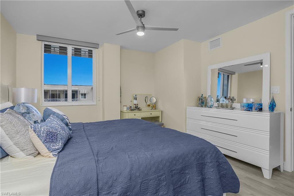 Recessed lighting, ceiling fan, expansive window, light wood-finish flooring, and light-toned walls