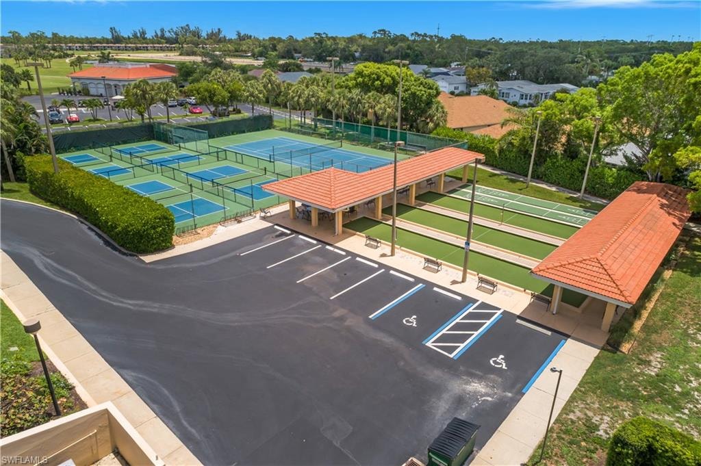 Dedicated parking facilities, multiple pickleball courts, tennis court, covered shuffleboard courts, and mature landscaping