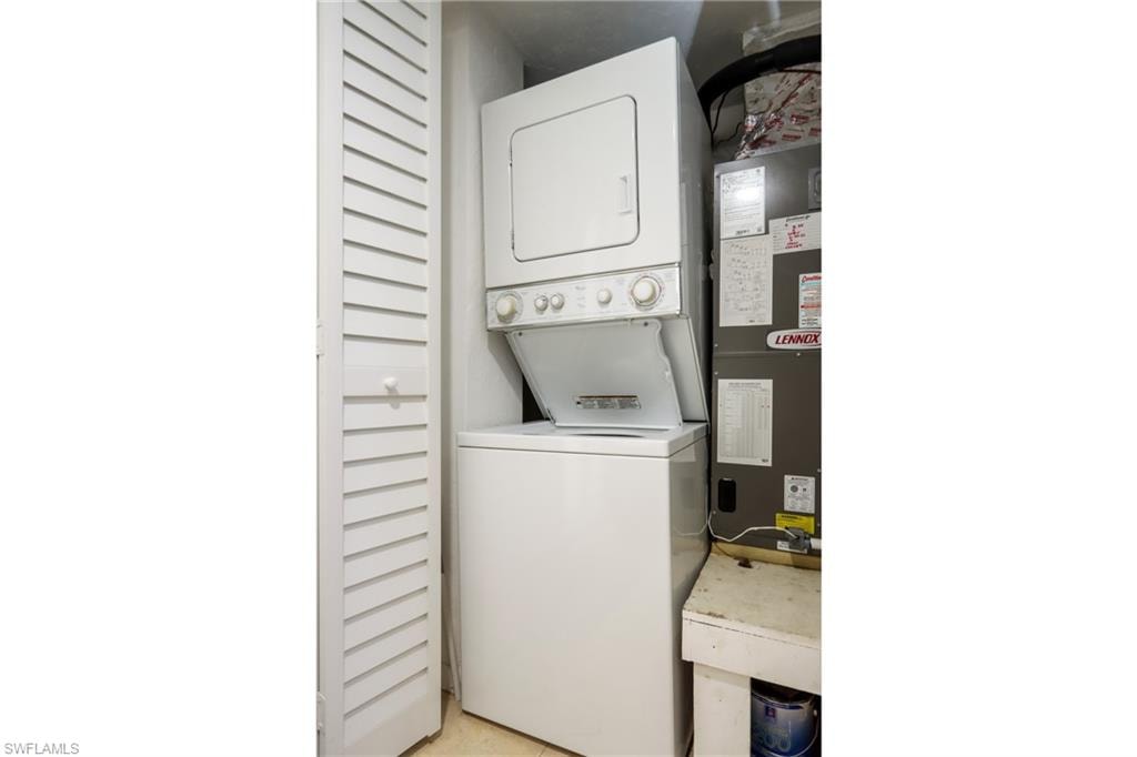 Laundry room with stacked washer / dryer and heating unit