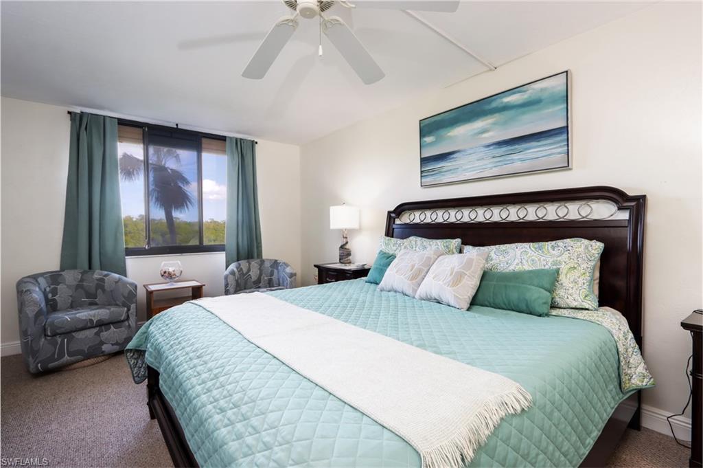 Bedroom with carpet floors, baseboards, and a ceiling fan