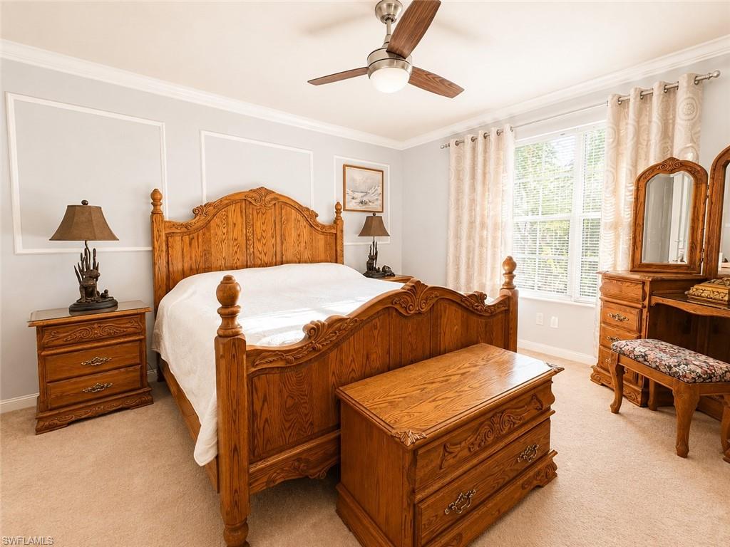 Wall molding accents, recessed window, ceiling fan with integrated lighting, wall-to-wall carpeting, crown molding