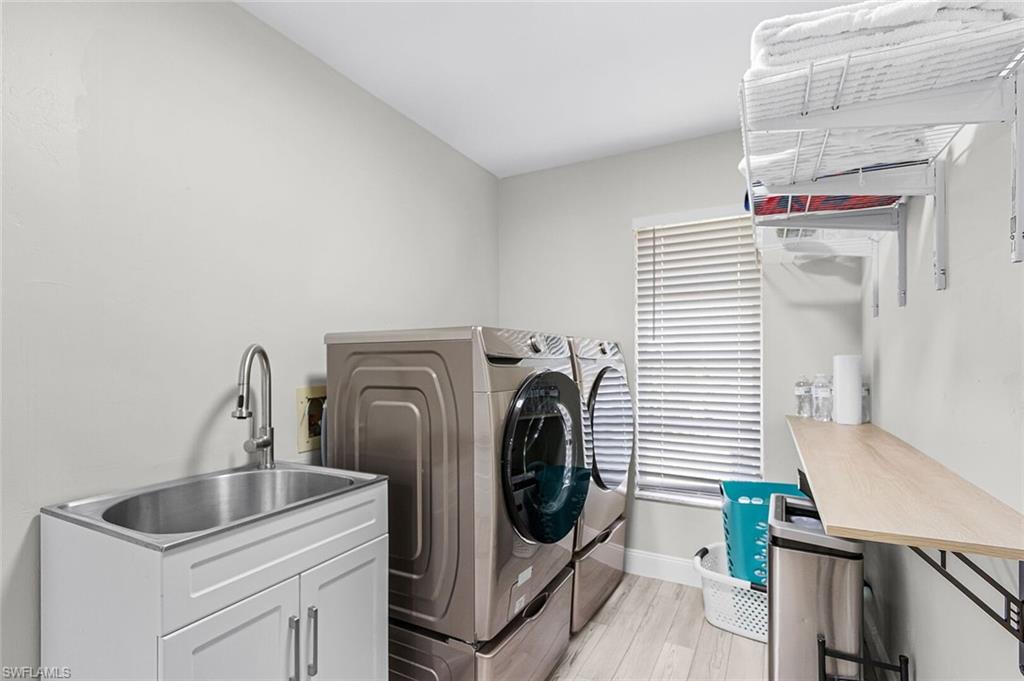 Light-toned wood-finish flooring, recessed lighting, and a spacious walk-in closet with built-in shelving