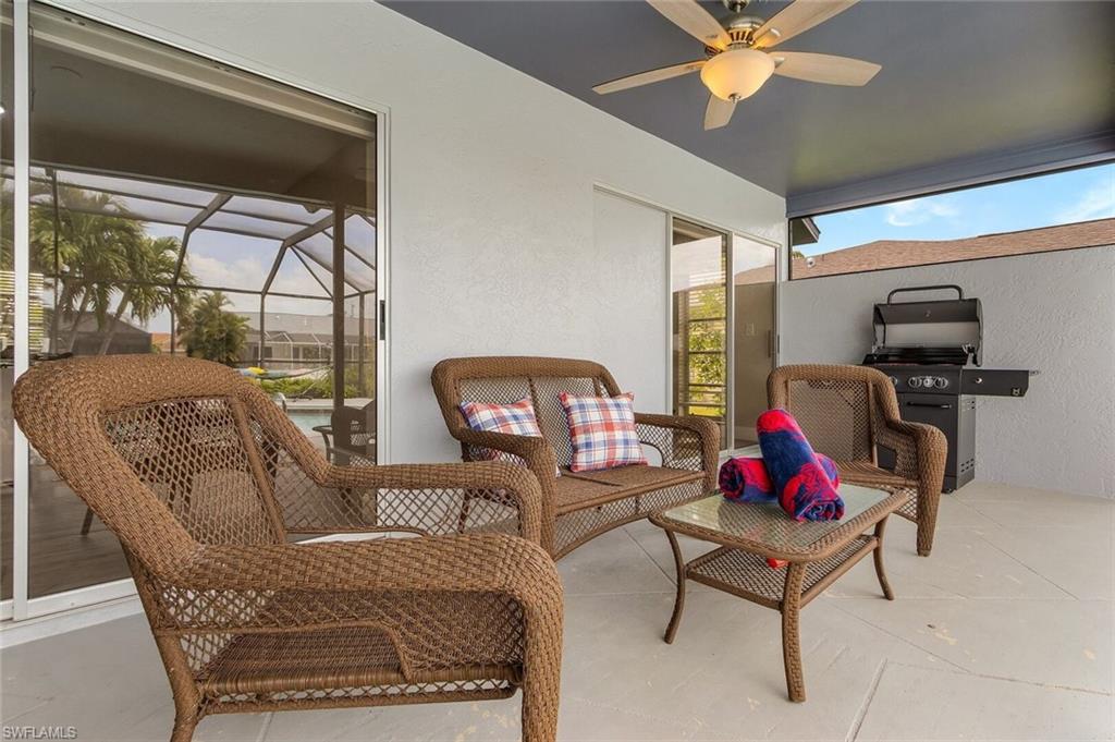 Screened enclosure featuring an oval-shaped pool with a textured concrete deck
