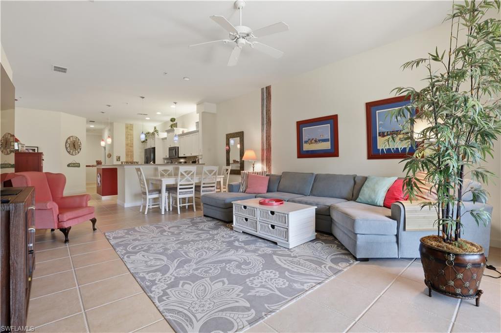 Open-concept living space with tile flooring, a ceiling fan, and recessed lighting