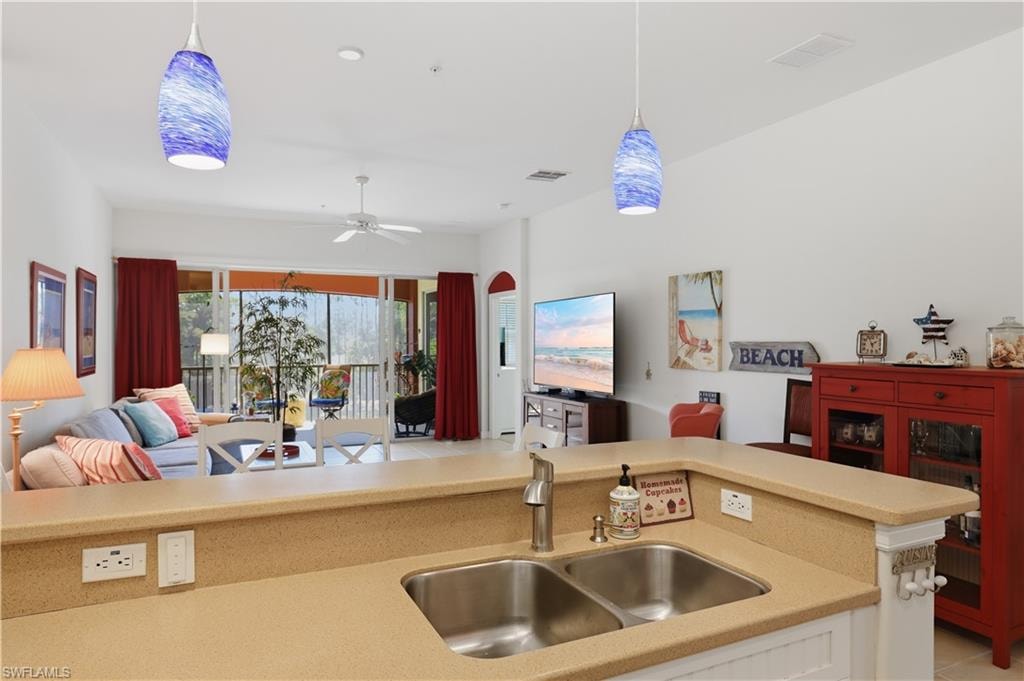 Kitchen features a double basin stainless steel sink and light-toned countertops