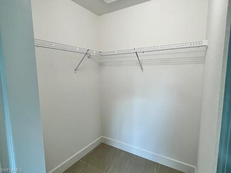 White wire shelving system, light-toned wall paint, neutral-toned floor tiling, white trim