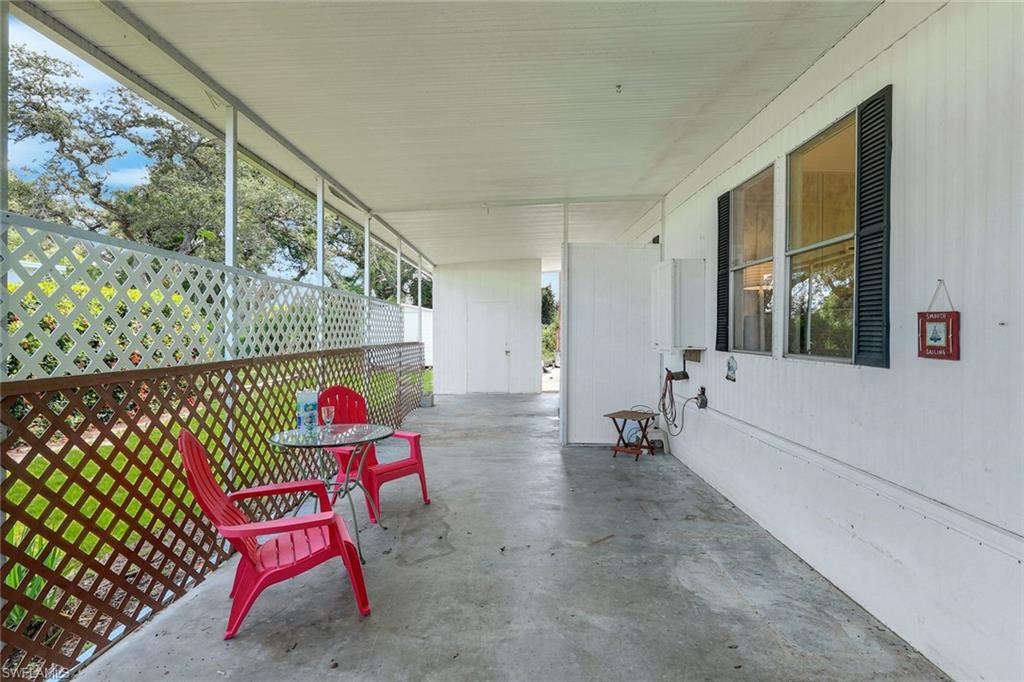 Covered area on North side of home connects to backyard and 3 storage sheds