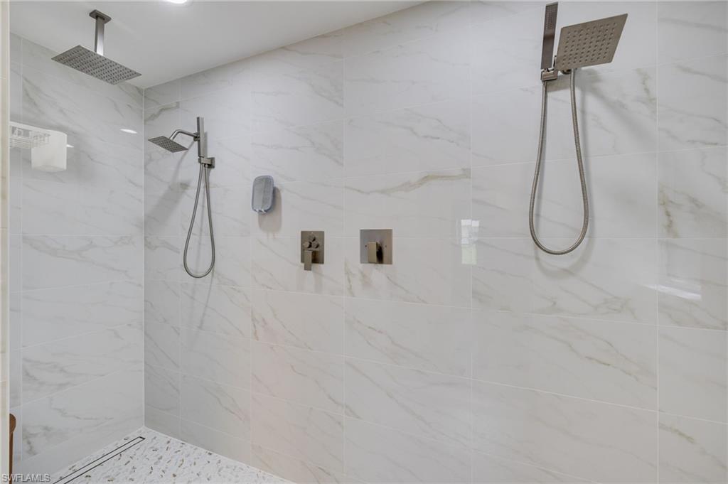Look at all those shower heads! Extra large newly tiled shower