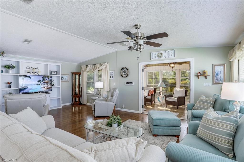 Wood-look flooring throughout the main living area and vaulted ceilings, Living Room opens to Florida Room.