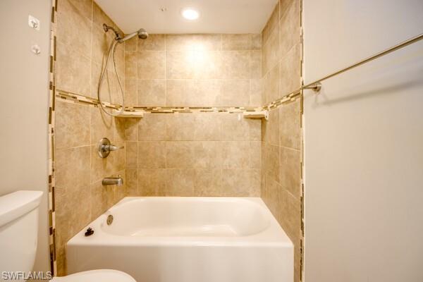 Bathroom featuring toilet and tiled shower / bath