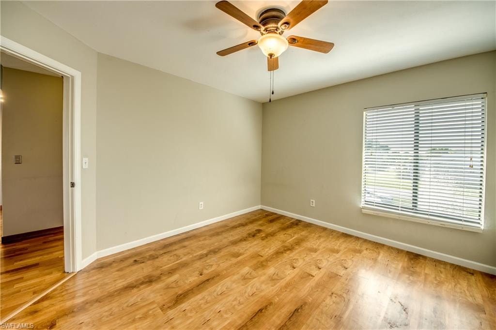 Unfurnished room with light hardwood / wood-style floors and ceiling fan