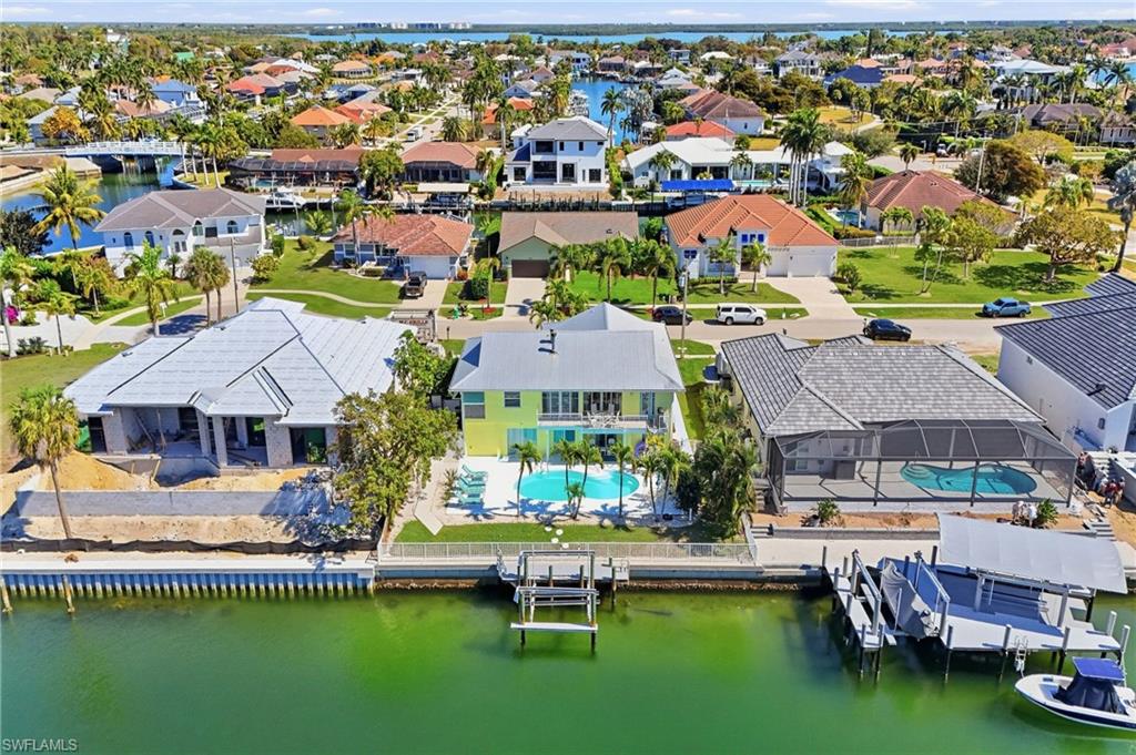 Waterfront property featuring an extensive seawall, private dock, and boat lift