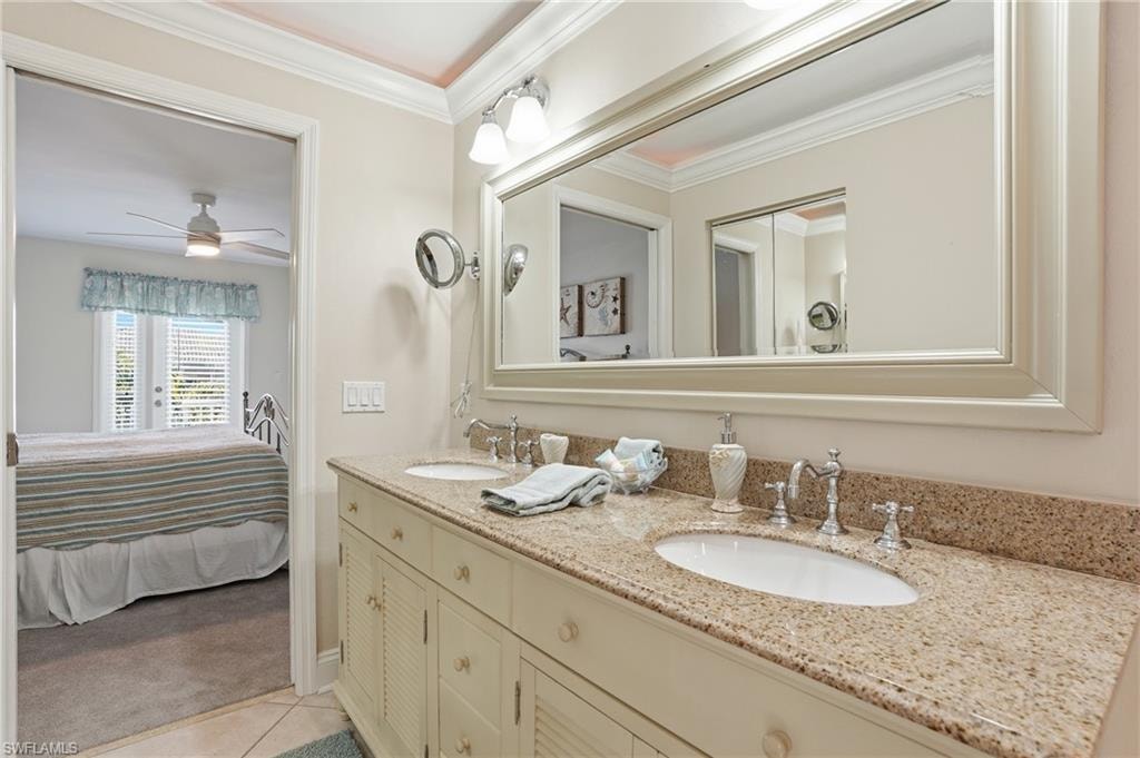 Dual vanity with an expansive countertop, individual undermount sinks, and chrome fixtures