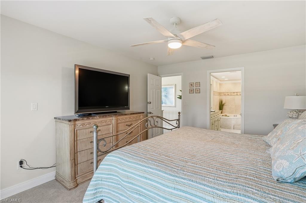Neutral wall paint, ceiling fan with integrated lighting, and carpeted flooring
