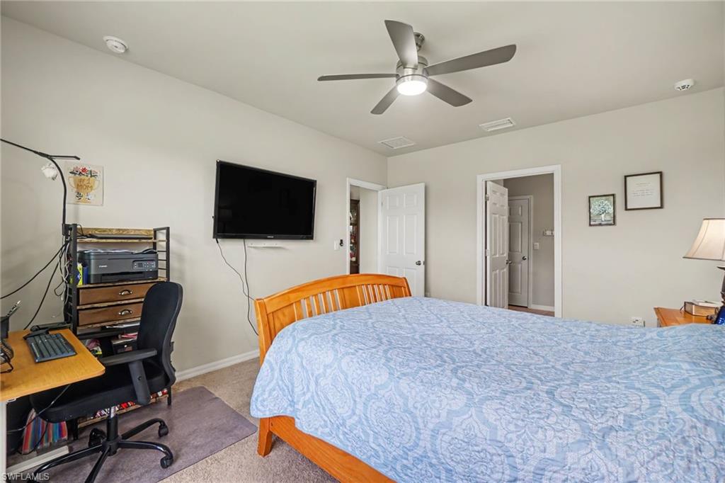 Spacious bedroom with fan with integrated lighting