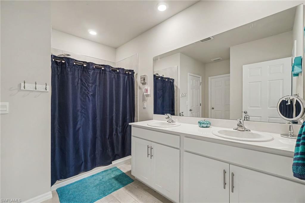 Dual vanity with undermount sinks, chrome fixtures, and a spacious countertop