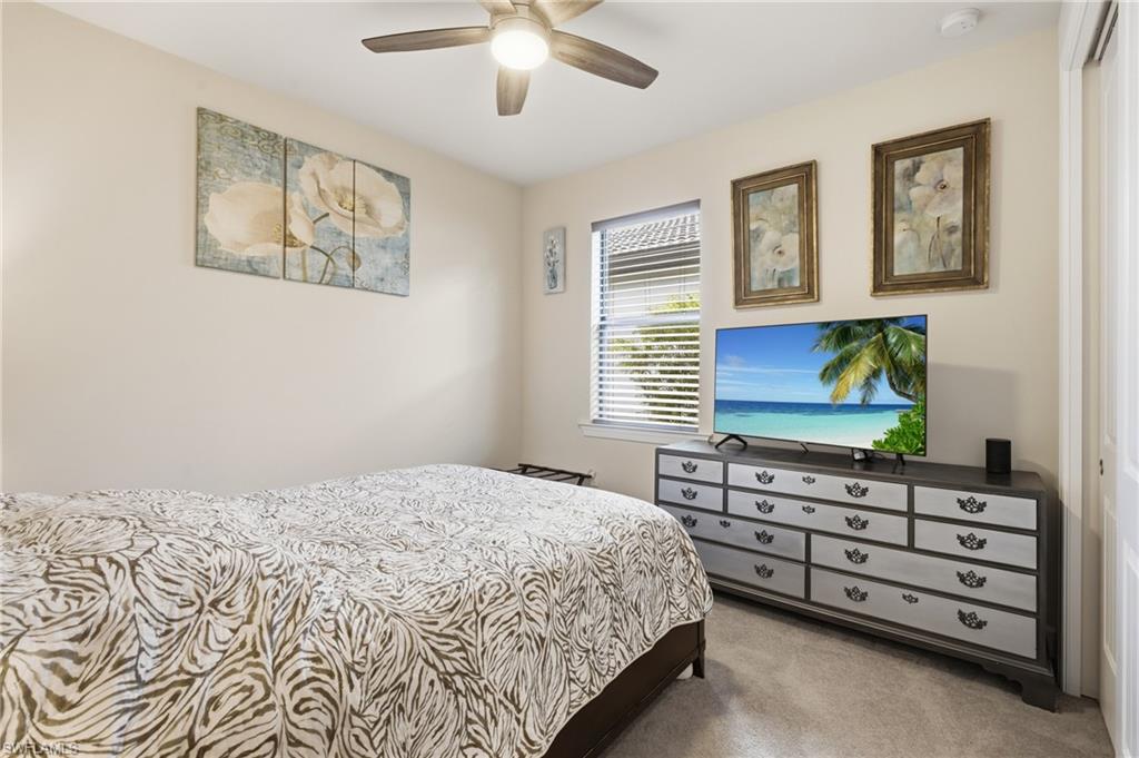 Recessed lighting and a ceiling fan fixture complement the neutral wall finishes