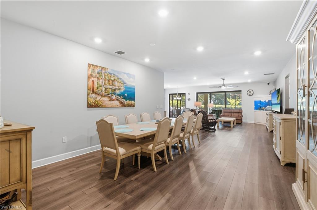Recessed lighting, wood-finish flooring, and sliding glass doors