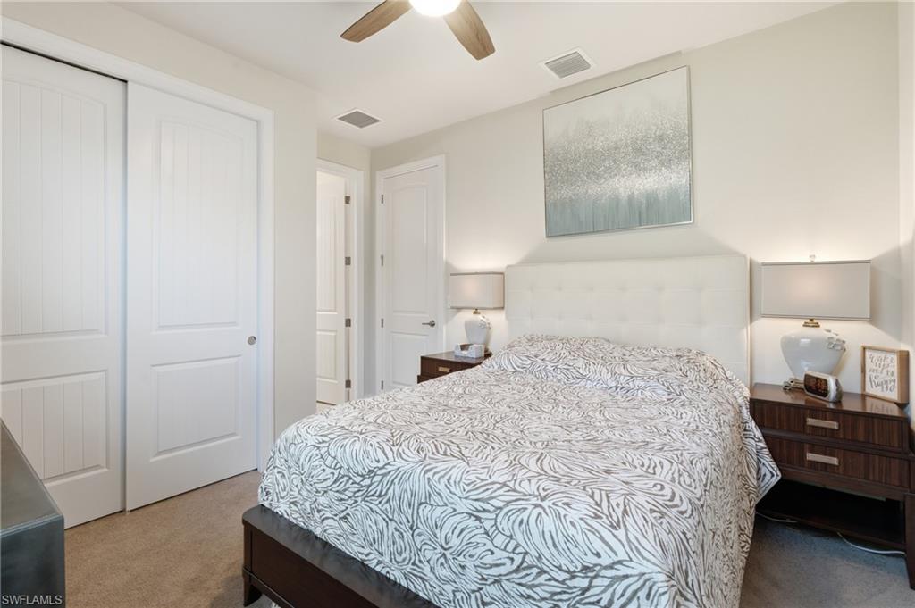 Neutral wall color, ceiling fan, recessed lighting, carpet flooring, paneled doors